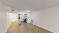 Located at 13008 Alexandria Dr in Opa-locka, FL, this single-floor unit offers 3 bedrooms and 2 bathrooms within a well-organized layout. The open living area is bright and spacious, featuring light wood-look flooring and neutral walls that create a clean, welcoming atmosphere. A textured ceiling adds architectural character, while a sliding glass door leads to a private balcony with views of lush greenery, allowing natural light to flow freely into the space.

The kitchen is thoughtfully designed with gray shaker-style cabinetry, marble-look countertops, black appliances including a refrigerator and electric range, and a double sink. A peninsula counter connects the kitchen to the living area, enhancing the open-concept feel.

All three bedrooms continue the wood-look flooring and maintain a consistent neutral palette. The primary bedroom is a comfortable size and features access to a closet. Additional bedrooms offer natural light through windows with vertical blinds. Two closets provide practical storage throughout the unit.

The bathroom includes full tile surround in a warm beige tone, a soaking tub with shower, a gray vanity with white countertop, and tile flooring, delivering a tidy and functional finish. Overall, this unit presents a clean, updated aesthetic suited for comfortable everyday living.