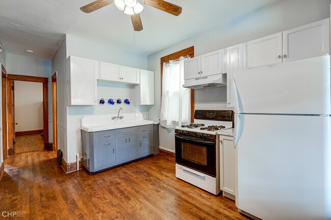 Restored vintage sink and new 36” cabinets. Apartment has same hardwood floors throughout - 1833 N Harding Ave