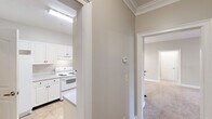 Located at 244 Kyser Blvd in Madison, Alabama, this single-floor residence offers a well-organized layout designed for comfortable everyday living. The interior is finished with a consistent neutral color palette of warm beige and gray tones, creating a cohesive and inviting atmosphere throughout.

The bedrooms are carpeted and feature ceiling fans with integrated lighting, textured ceilings, and windows with blinds that allow natural light to filter in while maintaining privacy. One bedroom connects directly to an en-suite bathroom and a generously sized walk-in closet outfitted with wire shelving and hanging rods, providing ample storage.

The bathrooms are practical and well-appointed. Each features a tub-shower combination, and the vanities include white cabinetry, laminate countertops, large mirrors, and Hollywood-style lighting fixtures. Tile flooring adds durability to the wet areas.

The kitchen is visible from adjacent rooms and is equipped with white cabinetry and appliances, maintaining the home's clean, understated aesthetic. The open sightlines between the kitchen and living areas contribute to a sense of connectivity across the floor plan.

Overall, this single-story home in Madison, AL offers a functional and comfortable living environment with practical storage solutions, natural light, and a neutral design that is move-in ready.