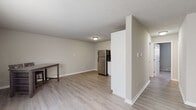Located at 1038 Woodstock Ln in Winchester, Virginia, this single-floor apartment offers a clean, functional layout designed for comfortable everyday living. The open living and dining area features light wood-style flooring and neutral gray walls, creating a bright, welcoming atmosphere. A partial dividing wall separates the living space from the kitchen, which is outfitted with stainless steel appliances — including a full-size refrigerator and electric range — complemented by white cabinetry and light countertops that lend a crisp, modern feel. The layout flows naturally between the kitchen and living areas, making the space feel open and connected. The unit includes two carpeted bedrooms, each featuring neutral tones, textured ceilings, and windows fitted with blinds that allow for natural light while maintaining privacy. Both rooms offer a comfortable, quiet retreat. The bathroom is clean and straightforward, featuring a tub-shower combination, a white vanity with a light stone-style countertop, a medicine cabinet with mirror, and chrome fixtures throughout. The overall aesthetic of the unit is simple and well-maintained, with consistent neutral tones and practical finishes throughout — making it a move-in ready home in Winchester, VA.