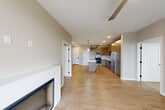 Located at 1113 Baywood Dr in Petaluma, CA, this well-appointed 2-bedroom, 2-bathroom single-story home offers a thoughtfully designed open-concept layout. Light wood-tone flooring flows throughout the main living areas, creating a warm and cohesive aesthetic. The combined kitchen and dining area serves as the heart of the home, showcasing contemporary flat-front wood cabinetry, a marble-look quartz waterfall island, pendant lighting, a full suite of stainless steel appliances, and a classic subway tile backsplash. A dedicated pantry provides additional storage convenience. The living room is bright and inviting, featuring a modern fireplace, a ceiling fan, and a glass door that opens to a private outdoor area, allowing natural light to fill the space. Both bedrooms are carpeted for comfort, with neutral tones and windows that let in natural light. Each bedroom benefits from dedicated closet space, including a walk-in closet with built-in shelving and hanging rods. The two bathrooms are clean and functional, with one featuring a full tub-shower combination. An in-unit laundry area adds everyday practicality to this move-in-ready home.
