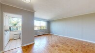 Located at 236 Vaughan Road, Suite 505, in Toronto's established Cedarvale neighbourhood, this one-bedroom, one-bathroom unit offers a well-organized layout across a single floor. Classic parquet hardwood flooring runs throughout the space, lending warmth and character to every room.

The living room is generously proportioned, featuring elegant crown moulding, soft neutral walls, and a large picture window that frames lush tree canopy views while flooding the room with natural light. A radiator beneath the window provides in-suite heating. The open, airy feel is enhanced by clean white baseboards and a bright, unobstructed ceiling.

The bedroom is a comfortable, well-sized retreat with its own window overlooking greenery, a radiator for warmth, and the same warm parquet flooring consistent throughout the unit. The neutral palette creates a calm and restful atmosphere.

The bathroom is finished with clean white subway-style wall tiles, a full soaker tub and shower combination, and a vanity topped with a marble-patterned countertop and an integrated sink, completed by a mirrored medicine cabinet above.

A hallway connects the rooms and provides functional flow throughout the unit. Overall, this space offers a classic, well-maintained interior with timeless finishes and pleasant natural outlooks in a sought-after Toronto neighbourhood.