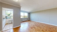 Located at 236 Vaughan Road, Suite 505, in Toronto's established Cedarvale neighbourhood, this one-bedroom, one-bathroom unit offers a well-organized layout across a single floor. Classic parquet hardwood flooring runs throughout the space, lending warmth and character to every room.

The living room is generously proportioned, featuring elegant crown moulding, soft neutral walls, and a large picture window that frames lush tree canopy views while flooding the room with natural light. A radiator beneath the window provides in-suite heating. The open, airy feel is enhanced by clean white baseboards and a bright, unobstructed ceiling.

The bedroom is a comfortable, well-sized retreat with its own window overlooking greenery, a radiator for warmth, and the same warm parquet flooring consistent throughout the unit. The neutral palette creates a calm and restful atmosphere.

The bathroom is finished with clean white subway-style wall tiles, a full soaker tub and shower combination, and a vanity topped with a marble-patterned countertop and an integrated sink, completed by a mirrored medicine cabinet above.

A hallway connects the rooms and provides functional flow throughout the unit. Overall, this space offers a classic, well-maintained interior with timeless finishes and pleasant natural outlooks in a sought-after Toronto neighbourhood.