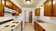 Located at 164 Brookmeadow Dr SW in Grandville, Michigan, this 2-bedroom, 1-bathroom single-floor unit offers a practical and comfortable layout. The galley-style kitchen is well-appointed with warm oak cabinetry, ample upper and lower storage, light-toned countertops, and white appliances including an electric range, refrigerator, and dishwasher. Tile flooring runs throughout the kitchen, while soft carpeting extends through the living areas and bedrooms. The open living and dining area is bright and welcoming, featuring a sliding glass door that invites natural light and provides direct access to the outdoors. The primary bedroom is generously sized, offering a walk-in closet and direct access to the full bathroom, which features a wood-toned vanity, tile flooring, and a full tub-shower combination. The second bedroom is a comfortable, carpeted room with a window overlooking greenery, providing a quiet and naturally lit retreat. A dedicated entrance completes the layout. Throughout the unit, warm wood trim accents the doors and baseboards, contributing to a cohesive and inviting aesthetic. This unit offers a straightforward and functional design well-suited for everyday living in a residential Grandville neighborhood.