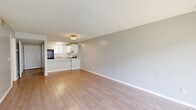 Located at 5821 San Juan Avenue in Jacksonville, FL, this single-story 2-bedroom, 1-bathroom home offers a thoughtfully laid-out floor plan with a clean, neutral aesthetic throughout. Light wood-look flooring flows seamlessly across the living spaces, complemented by soft gray walls and textured ceilings that add character to each room.

The combined living and dining area is open and airy, with vertical blinds allowing natural light to filter in from the front-facing window. This space connects directly to the kitchen, which features a raised peninsula counter — ideal as a breakfast bar or casual dining surface. The kitchen is outfitted with crisp white cabinetry, granite-look countertops, a stainless steel electric range, a black refrigerator, and a stainless steel sink beneath a window.

A hallway connects the living areas to the two bedrooms, both of which feature the same warm flooring, neutral walls, and ample closet space. The primary bedroom is generously sized, while the second bedroom includes a window offering natural light. The home boasts five closets in total, providing excellent storage throughout.

The full bathroom includes a wide vanity with granite-look countertops, a large mirror with framed lighting, and gold-toned fixtures. The layout is efficient and well-organized, making excellent use of the available space.