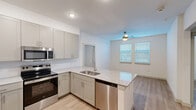 Located at 2600 Illinois Ave in Killeen, TX, this single-floor, 2-bedroom, 2-bathroom home offers a clean, modern aesthetic with thoughtful design throughout. The open-concept kitchen and living area serves as the heart of the home, featuring light gray shaker-style cabinetry, granite countertops, a peninsula island with a double-basin sink, and a full suite of stainless steel appliances including an electric range, built-in microwave, and dishwasher. Light wood-look flooring flows seamlessly through the main living areas, complemented by white walls and recessed lighting that create a bright, airy atmosphere. A ceiling fan in the living area adds comfort, while blinds on the windows allow for natural light control. The bedrooms are well-sized, with the primary bedroom offering direct access to a walk-in closet featuring built-in shelving, as well as a private en-suite bathroom equipped with a glass-enclosed walk-in shower. A second bedroom includes access to a door with natural light. Two closets throughout the unit provide ample storage. A hallway connects the living spaces efficiently. The overall design is contemporary and move-in ready, offering functional comfort in a well-organized floor plan.