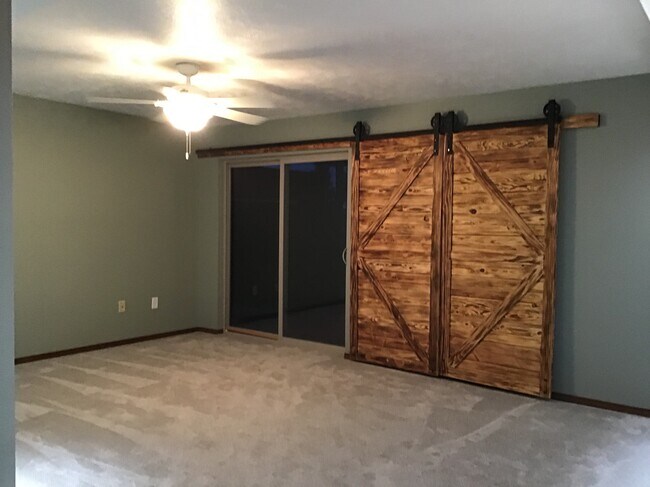 Lower level family room is a walk out with the barn door shutters - 4421 S Tribbey Trl