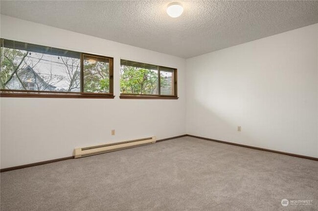 The unit features a large main bedroom and smaller second bedroom, perfect for an office. - 3033 21st Ave W