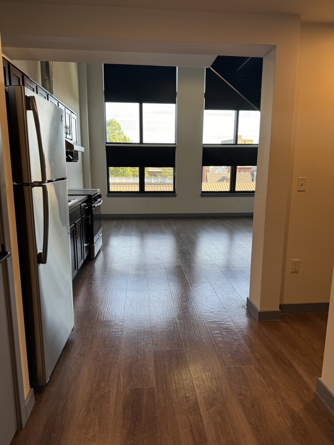 Kitchen area open concept to Living area - Queen City Lofts Apartments