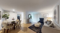 This single-floor residence offers a thoughtfully arranged layout that balances comfort and functionality. The living area is an inviting space finished with light tile flooring, white walls, and vertical blinds along a sliding glass door that allows natural light to fill the room. A tufted sofa, wingback chair, and layered navy area rug contribute to the room's refined yet approachable character, while a starburst wall piece serves as a focal point above the seating arrangement.

Adjacent to the living area, the dining space accommodates a round wooden table surrounded by tufted upholstered chairs, complemented by framed artwork and a potted plant that add warmth to the corner setting.

The kitchen features dark espresso cabinetry, granite countertops, a stainless steel sink, and tile flooring. Black appliances and a window with blinds complete the space, providing both practicality and a clean aesthetic.

The bedrooms are carpeted and include ceiling fans with integrated lighting. Each room offers windows with blinds that allow natural light while maintaining privacy. The bedroom spaces are comfortably sized with room for standard furniture arrangements.

The bathroom includes a tiled tub-shower combination with dark granite-style surround, tile flooring, and a clean, functional layout. Throughout the residence, the neutral palette and consistent finishes create a cohesive and livable environment.