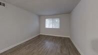 Located at 1276 Corsair Dr in Virginia Beach, VA, this one-bedroom, one-bathroom residence offers a thoughtfully designed single-floor layout that maximizes every square foot. The open combined dining and living area features durable hardwood-style flooring and neutral gray walls, creating a clean, versatile space filled with natural light from a large window. The galley-style kitchen is a standout feature, boasting granite countertops, dark-toned cabinetry with sleek hardware, a stainless steel sink, dishwasher, and refrigerator — delivering both style and functionality in a compact footprint. The bedroom is carpeted for comfort, with a bright window overlooking greenery outdoors, and benefits from convenient access to the hallway and multiple closets — five in total — providing exceptional storage throughout the unit. The bathroom is clean and functional, featuring a full soaking tub and shower combination with a chrome fixture, complemented by light flooring and a crisp white finish. A hallway connects the main living areas efficiently, contributing to the home's smooth flow. The neutral color palette and modern finishes throughout give the space a fresh, move-in-ready appeal suitable for a range of lifestyles.