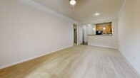 Located at Abberly Village Circle in West Columbia, SC, this one-bedroom, one-bathroom residence offers a well-designed, single-floor layout that maximizes comfort and functionality. The open-concept living and dining area is finished with plush carpeting, crown molding, a ceiling fan, and a sliding glass door that opens to a private balcony, filling the space with natural light and outdoor views. The kitchen features warm honey-toned cabinetry, granite-style countertops, hardwood-style flooring, and a full suite of black appliances including a refrigerator, range, microwave, and dishwasher — all accessible via a convenient pass-through counter. The generously sized bedroom is carpeted with a large window that lets in ample sunlight, along with a closet for storage. The bathroom is appointed with a warm wood vanity, granite-style countertops, a large mirror, and hardwood-style flooring. A dedicated laundry area with side-by-side washer and dryer connections adds everyday convenience. A connecting hallway ties all rooms together, creating a cohesive and practical floor plan ideal for comfortable single-occupant living.