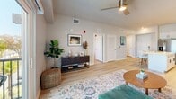 Located at 265 Avenue E SW in Winter Haven, Florida, this well-designed one-bedroom, one-bathroom residence offers a thoughtfully laid-out floor plan with modern finishes throughout. Light-toned wood-style flooring flows seamlessly across the entire space, creating a cohesive and airy aesthetic.

The open-concept kitchen and living area serves as the heart of the home. The kitchen is outfitted with crisp white cabinetry extending to the ceiling for ample storage, a clean white tile backsplash, stainless steel appliances including a refrigerator, range, microwave, and dishwasher, and a center island with seating for two. Track lighting overhead ensures the kitchen is well-illuminated. The adjoining living room is bright and open, featuring a ceiling fan, and sliding glass doors that lead to a private balcony overlooking the outdoors.

A hallway connects the living area to the private bedroom, which offers a ceiling fan, a natural light-filled window, and comfortable proportions. The bathroom features a white vanity with storage, a large mirror, and light wood-style flooring. An adjacent walk-in closet provides convenient, organized storage space.

Throughout the unit, neutral wall tones, clean lines, and modern fixtures combine to create a bright, contemporary atmosphere well-suited to everyday living in central Florida.