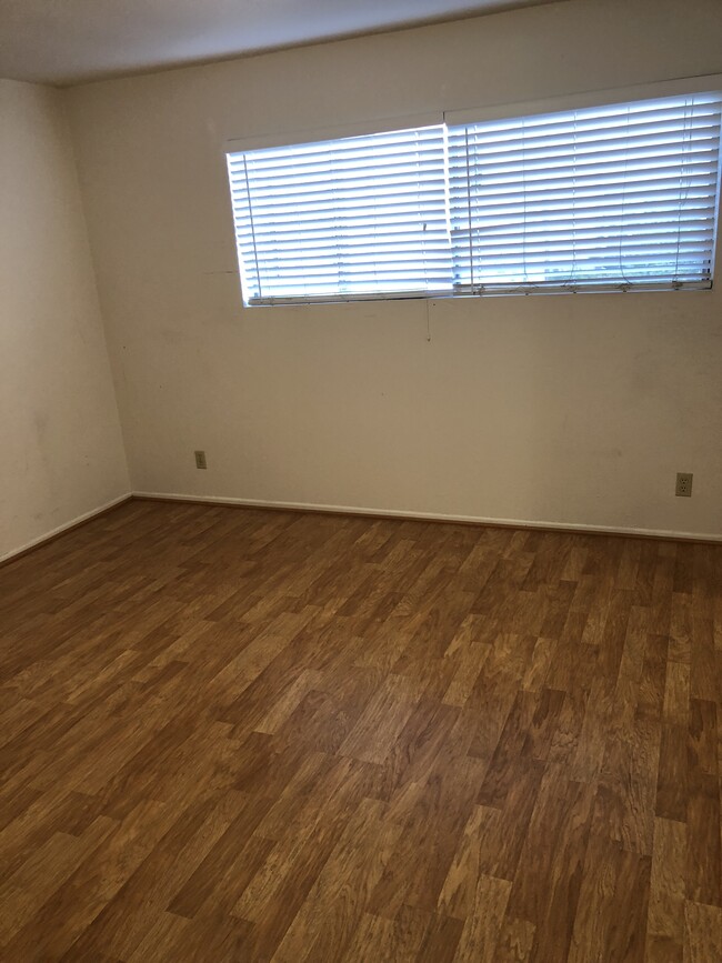 Bedroom with Wood plank floors - 408 Ellwood Beach Dr