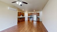 Located at 4525 Secret Garden Dr in Madison, WI, this single-floor, 2-bedroom, 2-bathroom home offers a well-organized layout designed for comfortable everyday living. The open-concept kitchen and living area serves as the heart of the home, featuring warm wood-toned cabinetry, dark granite countertops, stainless steel appliances, and recessed lighting. Rich hardwood-style flooring flows throughout the living area, complemented by a ceiling fan with light fixture. A sliding glass door in the living room fills the space with natural light and provides direct access to the outdoors. Both bedrooms are carpeted and include wall-mounted mini-split units for individual climate control, along with windows that offer neighborhood views. The spacious primary bedroom includes a generous walk-in closet outfitted with multi-tiered shelving and hanging rods. The bathrooms feature warm tile flooring, rich wood vanities with granite countertops, and a tiled walk-in shower. The attached garage provides ample space for parking and additional storage, with a concrete floor and automatic door opener. The property also benefits from a well-maintained exterior with green landscaping, adding to its welcoming curb appeal.
