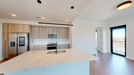 This contemporary 1240 square foot apartment in Atlanta offers a harmonious blend of style and functionality. The open-concept design seamlessly integrates the kitchen and living areas, creating a spacious feel enhanced by abundant natural light from floor-to-ceiling windows. The sleek kitchen boasts light wood cabinetry, stainless steel appliances, and a generous island with a sink, perfect for both meal preparation and casual dining.

Two bedrooms, including a 150 square foot primary, provide ample personal space. Three well-appointed bathrooms feature modern fixtures, with at least one showcasing a luxurious bathtub. The apartment's storage solutions include multiple closets and built-in shelving.

Hardwood floors throughout lend warmth to the crisp white walls, while recessed lighting and a statement pendant in the kitchen add to the modern aesthetic. Large sliding glass doors open to a balcony, offering breathtaking city views and extending the living space outdoors.

Located at 10 Tower Rd NW in Atlanta, this single-floor residence combines urban sophistication with comfortable living, making it an ideal home for those seeking a contemporary lifestyle in the heart of the city.