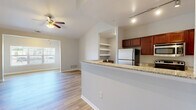 Located at 2728 Golden Currant View in Colorado Springs, CO, this single-floor, 2-bedroom, 2-bathroom home offers a thoughtfully designed layout with modern finishes throughout. Light-toned wood-style flooring extends across the entire residence, creating a cohesive and clean aesthetic in every room.

The open-concept kitchen and living area serves as the heart of the home. The kitchen features rich dark wood cabinetry, granite-style countertops, stainless steel appliances including a full-size refrigerator and range, and a peninsula that connects seamlessly to the living space. Built-in open shelving adds functional display space. The adjoining living room benefits from vaulted ceilings, a ceiling fan, and natural light flowing from a large window.

Both bedrooms are generously sized, each equipped with ceiling fans, large windows fitted with blinds, and dedicated closet space. The primary bedroom offers a comfortable and private retreat. The two bathrooms mirror the home's overall design language, featuring dark wood vanities with granite-style countertops and tub/shower combinations with brushed nickel grab bars.

A dedicated laundry room houses a full-size washer and dryer with overhead wire shelving for additional storage. The hallway connects all spaces efficiently, and two closets provide ample storage throughout the home.