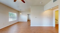 Located at 1600 Mustang Dr in Marble Falls, TX, this well-designed 2-bedroom, 3-bathroom unit offers a comfortable and functional single-floor layout. Wood-look flooring flows consistently throughout the entire space, giving it a cohesive and clean appearance.

The open living room is bright and airy, featuring vaulted ceilings, a ceiling fan, and multiple windows with horizontal blinds that invite generous natural light and outdoor views of surrounding greenery. A pendant light fixture highlights the dining area, which connects seamlessly to the galley-style kitchen. The kitchen is equipped with warm oak cabinetry, white countertops, a double sink, a range, and a dishwasher, along with a pantry closet for additional storage.

Both bedrooms are well-proportioned, each featuring a ceiling fan, a window overlooking the outdoors, and a double-door closet for ample storage. The primary bedroom offers a notably spacious footprint. The three bathrooms are consistent in finish, each featuring warm oak vanity cabinetry, white countertops, a large mirror, and overhead lighting. One bathroom includes a full soaking tub, while others include accessibility features such as grab bars. A central hallway connects the bedrooms and bathrooms, providing a practical and easy-to-navigate flow throughout the home.