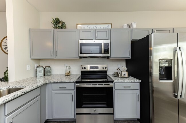 Kitchen with granite counters and stainless appliances - Sango Ridge