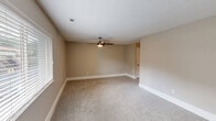 Located at 1000 Beacon Pkwy E in Birmingham, AL, this single-floor unit offers a functional and comfortable layout with two bedrooms and one bathroom. The living area features plush carpet flooring, a ceiling fan with light fixture, and a front-facing window that brings in natural light — creating a welcoming entry point into the space. The kitchen is efficiently designed with white cabinetry, granite-look countertops, a double-basin sink, and black appliances including an electric range and refrigerator. A sliding glass door with vertical blinds opens to an outdoor balcony, offering views of surrounding greenery and allowing additional natural light into the space. The primary bedroom is generously sized, with soft carpeting, a ceiling fan, and a window overlooking lush outdoor trees, providing a calm and private atmosphere. The second bedroom mirrors this comfort with neutral-toned walls, carpet flooring, and a ceiling fan. The bathroom features a full tub-shower combination with clean white surrounds and chrome fixtures. Throughout the unit, neutral wall colors, textured ceilings, and consistent trim work contribute to a cohesive and move-in ready aesthetic.