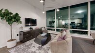 Located at 1000 W 8th St in Downtown Los Angeles, this sophisticated 2-bedroom, 3-bathroom residence offers a seamlessly designed single-floor layout with refined modern finishes throughout. The open-concept living, dining, and kitchen area is anchored by dramatic floor-to-ceiling windows that frame striking city views and flood the space with an urban glow. The gourmet kitchen features sleek wood cabinetry, dark granite countertops and backsplash, a gas cooktop, and a built-in wine refrigerator — all flowing naturally into the dining and living areas. The spacious primary bedroom offers textured accent wallpaper, hardwood flooring, large windows with city views, and access to generous walk-in closet space. A second well-appointed bedroom also enjoys a decorative ceiling fixture and its own closet access. Three elegantly finished bathrooms feature large-format marble tile, soaking tubs, and warm wood vanities. Additional highlights include a dedicated laundry area, a pantry, a welcoming entryway with contemporary décor, and an abundance of closet storage — six in total — ensuring practicality matches the home's polished aesthetic.
