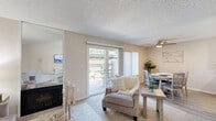 Located at 2424 Hurley Way in Sacramento, CA, this two-bedroom, two-bathroom residence offers a thoughtfully organized single-floor layout. The living room features neutral-toned carpet, a textured ceiling, and a cozy fireplace framed by mirrored panels that add depth to the space. A hallway connects the living area to the rest of the home seamlessly.

The kitchen is efficiently designed with white cabinetry, ample counter space, and wood-look flooring. It comes equipped with a full-size range, refrigerator, and dishwasher, offering everything needed for daily cooking. Adjacent to the kitchen, the dining area is bright and welcoming, featuring wood-look flooring, a ceiling fan with light, and a window that invites natural light and outdoor views.

The spacious primary bedroom is carpeted for comfort and includes generous wall space and natural light from a window. The second bedroom is similarly finished, offering a calm, neutral palette. Both bathrooms are clean and functional — one features a tub/shower combo and the other includes a vanity with updated hardware and wood-look flooring. A dedicated closet and hallway round out the interior. The overall ambiance is light, neutral, and move-in ready.