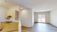 This contemporary 2-bedroom apartment in Red Deer, Alberta, offers 71 square meters of well-designed living space. The open concept layout seamlessly integrates the kitchen, living, and dining areas, creating a spacious feel. Light wood-look flooring runs throughout, complementing the neutral wall tones and adding warmth to the space.

The kitchen features light wood cabinetry, white appliances, and a practical peninsula that doubles as a breakfast bar. Adjacent to the kitchen is a dedicated laundry area with a stacked washer and dryer, enhancing convenience.

Both bedrooms are generously sized, with the primary bedroom measuring 13 square meters. They offer ample closet space with sliding doors and large windows for natural light. The bathroom is efficiently designed with a shower/tub combination, single vanity, and modern fixtures.

A standout feature is the balcony accessible through sliding glass doors, providing outdoor space and additional natural light. Throughout the apartment, baseboard heating ensures comfort in colder months. The neutral color palette and clean lines create a contemporary ambiance, allowing for personalization to suit various tastes.