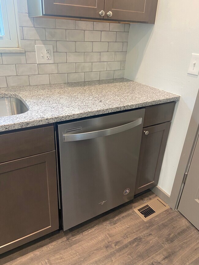 Remodeled Kitchen with granite counters, tile backsplash, and new appliances - 174 Brisbane Ave