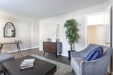 Located at 1 Hempstead Heath Way in Hampton, Virginia, this two-story home offers a thoughtfully designed layout across both levels. The kitchen is a standout feature, showcasing rich dark-espresso cabinetry, light granite countertops, stainless steel appliances including a range, microwave, dishwasher, and refrigerator, all set atop warm wood-look flooring. A breakfast bar with seating adds both function and style to the space. Natural light filters through the windows, enhancing the bright, open feel of the kitchen.

The living room is generously proportioned, featuring the same wood-look flooring and neutral-toned walls that lend a clean, cohesive aesthetic throughout the main level. The space flows comfortably and offers room for multiple seating arrangements.

The bedrooms are carpeted for comfort, with the primary bedroom featuring ample space, abundant natural light, and access to a well-appointed bathroom. The bathrooms are finished with classic white subway tile, wood-look flooring, and dark cabinetry for storage.

A dedicated in-unit laundry area houses a full-size washer and dryer, adding everyday convenience. Throughout the home, the design balances practical functionality with a clean, welcoming aesthetic suited for comfortable residential living.