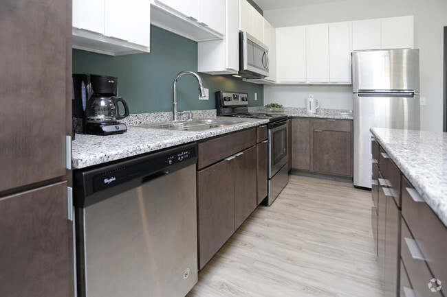 Kitchen with Stainless Steel Finishes - Uptown Apartments