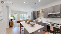 Located in Morrisville, NC, this thoughtfully designed one-bedroom, one-bathroom residence offers a functional and modern living experience across a single floor. The open-concept kitchen and living area serves as the heart of the home, where the two spaces flow seamlessly together. The kitchen is outfitted with gray shaker-style cabinetry, stainless steel appliances including a range, microwave, dishwasher, and refrigerator, white subway tile backsplash, and a large central island with white countertops that doubles as a dining and prep space. Light wood flooring runs throughout, adding warmth to the clean, neutral palette. The living area benefits from generous natural light streaming through large windows and a glass door that opens to a private balcony with outdoor views. The bedroom is a calm, well-proportioned retreat featuring tall ceilings, additional windows for natural light, and direct access to a dedicated closet. The bathroom features gray vanity cabinetry that coordinates with the kitchen, a framed mirror, modern light fixtures, and a walk-in shower. A hallway connects the spaces efficiently, completing this cohesive and practical layout ideal for modern living.