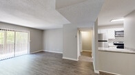 Located at 927 Honeysuckle Rd in Dothan, Alabama, this single-floor, one-bedroom, one-bathroom home offers a practical and cohesive layout designed for comfortable everyday living. Wood-look plank flooring and warm neutral-toned walls are consistent throughout, creating a clean and unified aesthetic.

The living room is the largest area of the home, providing generous open space for flexible furniture arrangements. Textured ceilings add subtle character, while multiple electrical outlets along the walls offer functional versatility. The living room flows naturally toward a hallway that connects the remaining rooms.

The kitchen is a standout feature, showcasing white cabinetry, light stone-look countertops, a classic white subway tile backsplash, a double stainless steel sink, and stainless steel appliances including a range and microwave. The bright, well-appointed design makes this an efficient and attractive cooking space.

The bedroom is comfortably sized, featuring a window that allows natural light to filter in, and direct access to a spacious walk-in closet outfitted with dual clothing rods and shelving on multiple walls — offering excellent storage capacity.

The bathroom is straightforward and functional, featuring a tub-shower combination, toilet, and wood-look flooring that matches the rest of the home. A hallway completes the layout, connecting all spaces efficiently within this well-organized residence.