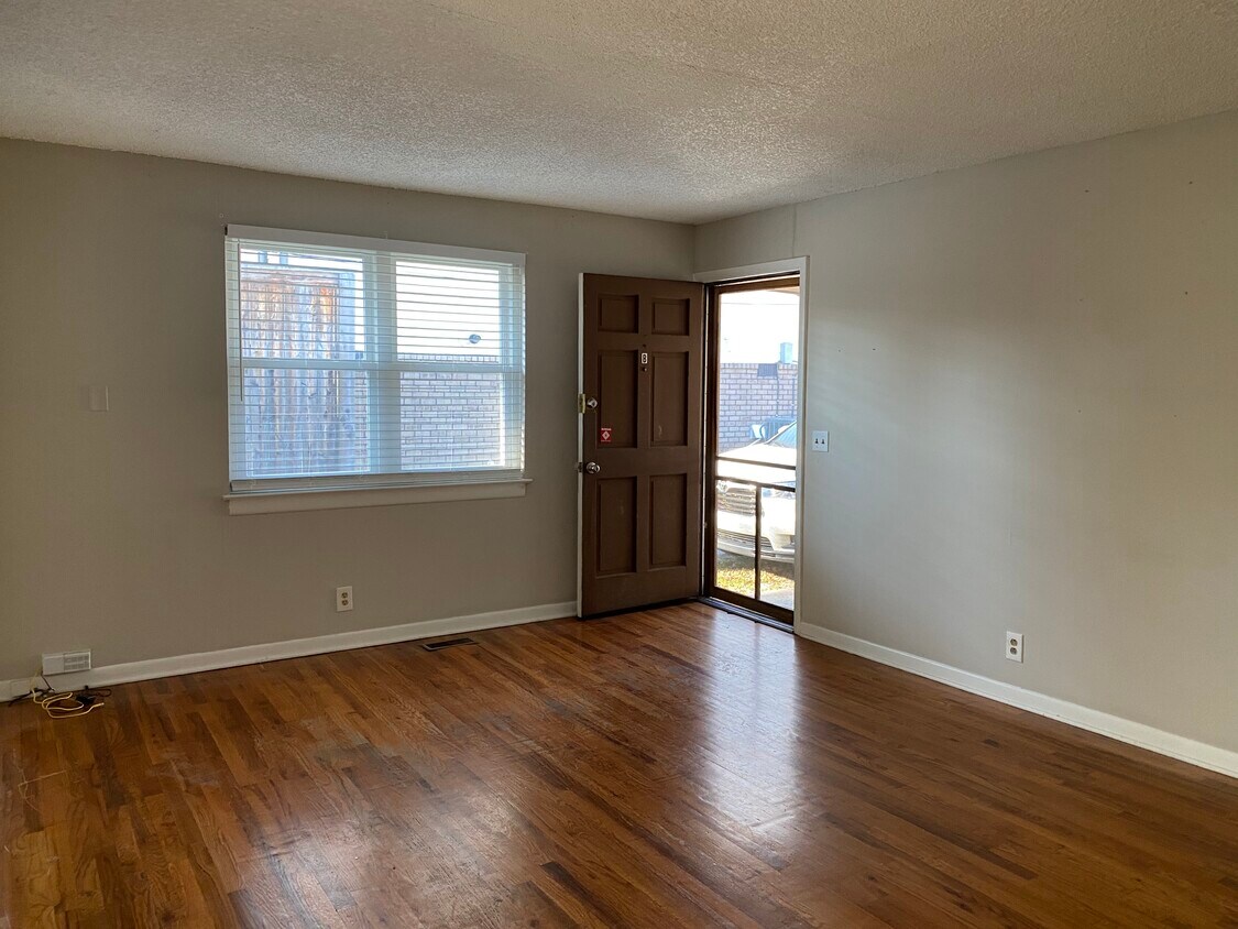 From the front entrance, you enter into the living room with a nice large new window. - 1003 Lawrence Ave