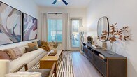 Located at 3108 McGinnis Ferry Rd in Suwanee, GA, this well-appointed 2-bedroom, 2-bathroom residence offers a thoughtfully designed single-floor layout with a clean, contemporary aesthetic throughout. The open-concept living, dining, and kitchen area forms the heart of the home, where light wood-style flooring, neutral white walls, and abundant natural light from large windows and a glass balcony door create an inviting atmosphere. A ceiling fan adds both style and function to the living space.

The kitchen is a standout feature, showcasing grey shaker cabinetry, stainless steel appliances, a subway tile backsplash, and a generous granite-topped island with seating — illuminated by modern globe pendant lights. The dining area flows seamlessly from the kitchen, making the space ideal for entertaining.

Both bedrooms are comfortably sized, with the primary bedroom offering a spacious walk-in closet and an en-suite bathroom featuring a glass-enclosed shower, granite vanity countertop, and grey cabinetry with matte black hardware. The second bathroom mirrors the same refined finishes. Three total closets provide ample storage throughout. A dedicated laundry area adds everyday convenience, completing this well-rounded and modern Suwanee residence.
