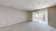 Located at 321 Imperial Blvd in Lakeland, Florida, this single-floor, 2-bedroom, 1-bathroom home offers a functional and comfortable layout with neutral finishes throughout. The living room features soft carpeting, a textured ceiling, and a sliding glass door fitted with vertical blinds that opens to an outdoor view of mature trees, allowing natural light to fill the space.

The kitchen stands out with crisp white cabinetry, granite-style countertops, a peninsula with beadboard detailing, light wood-look flooring, and black appliances including a full-size refrigerator — all complemented by a bright window above the sink.

The primary bedroom is a comfortable size, with plush carpeting, a ceiling fan with light fixture, a natural light-admitting window with blinds, and a large sliding closet. The secondary bedroom also features carpeting, a ceiling fan, and a sliding closet, providing ample storage. Both rooms maintain a calm, neutral palette.

The full bathroom is clean and well-appointed, featuring a white vanity with storage, a mirror, wood-look flooring, and a full tub-shower combination. Two hallways connect the rooms efficiently, contributing to a logical and easy-to-navigate floor plan throughout this well-maintained Lakeland home.