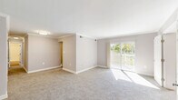 Located at 2134 Alice Ave in Oxon Hill, MD, this 2-bedroom, 2-bathroom residence offers a thoughtfully organized single-floor layout with a comfortable, functional design throughout. The living room is bright and spacious, featuring soft carpeting, neutral walls with crown molding, and sliding glass doors that open onto a private balcony overlooking a lush, tree-lined green space — an ideal spot to enjoy natural scenery. The kitchen is equipped with warm wood cabinetry, granite-style countertops, a gas range, and a window that fills the space with natural light and outdoor views. The generously sized primary bedroom offers plush carpeting, a natural light-filled window with vertical blinds, and ample storage. An additional bedroom and a den provide flexible living options, while five closets throughout ensure excellent storage capacity. The two bathrooms are cleanly finished with tiled walls, a vanity with mirror cabinet, and a full bathtub with shower. A hallway connects the rooms for a smooth and efficient flow. Neutral tones and carpet flooring are consistent throughout, giving the home a cohesive, calm aesthetic well-suited for everyday living.