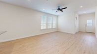 Located at 2750 Gathering Pl in Midlothian, TX, this two-story home offers four bedrooms and three bathrooms across a well-designed layout. The main floor provides a generous living area anchored by an open-concept kitchen and living room. The kitchen is a standout, showcasing white shaker cabinetry, a subway tile backsplash, granite countertops with a large island, a stainless steel farmhouse-style faucet, and stainless steel appliances including a gas range, microwave, and refrigerator. Light hardwood flooring flows throughout the main living areas, complemented by recessed lighting and an abundance of natural light from large windows with blinds. The primary bedroom features hardwood-style flooring, a ceiling fan, and a bank of windows overlooking the neighborhood. Its ensuite bathroom impresses with a frameless sliding glass shower encased in floor-to-ceiling marble-style tile. Secondary bedrooms on the upper floor offer plush carpeting and closets. Additional bathrooms include a full tub-shower combo with coordinating marble-style tile. A dedicated laundry room with washer and dryer, a hallway, and a walk-in closet with built-in shelving round out the functional layout of this well-appointed home.