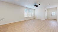Located at 2750 Gathering Pl in Midlothian, TX, this two-story home offers four bedrooms and three bathrooms across a well-designed layout. The main floor provides a generous living area anchored by an open-concept kitchen and living room. The kitchen is a standout, showcasing white shaker cabinetry, a subway tile backsplash, granite countertops with a large island, a stainless steel farmhouse-style faucet, and stainless steel appliances including a gas range, microwave, and refrigerator. Light hardwood flooring flows throughout the main living areas, complemented by recessed lighting and an abundance of natural light from large windows with blinds. The primary bedroom features hardwood-style flooring, a ceiling fan, and a bank of windows overlooking the neighborhood. Its ensuite bathroom impresses with a frameless sliding glass shower encased in floor-to-ceiling marble-style tile. Secondary bedrooms on the upper floor offer plush carpeting and closets. Additional bathrooms include a full tub-shower combo with coordinating marble-style tile. A dedicated laundry room with washer and dryer, a hallway, and a walk-in closet with built-in shelving round out the functional layout of this well-appointed home.