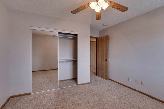 Bedroom with Closet - Springcreek Apartments and Townhomes