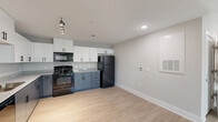 Located at 134 Prospect St in Greenville, SC, this single-story, 3-bedroom, 2-bathroom home offers a clean, modern design throughout. Light wood-look flooring runs continuously across the open layout, creating a cohesive and inviting atmosphere.

The kitchen and living area form a combined open-plan space, anchored by a well-equipped kitchen featuring two-tone cabinetry — white upper cabinets paired with slate-gray lower cabinets — granite-look countertops, a full suite of black appliances including a refrigerator, range, microwave, and dishwasher, and a track lighting fixture overhead.

Each of the three bedrooms is finished with the same light flooring and neutral wall tones, with ceiling fans providing comfort and natural light filtering in through windowed blinds. The generously sized primary bedroom includes a closet and direct access to additional spaces. The bedrooms offer a calm, versatile environment suitable for a variety of uses.

The two bathrooms are clean and functional, with one featuring a full tub-shower combination with chrome fixtures. An in-unit laundry area houses a full-size washer and dryer with wire shelving above, adding everyday convenience. A hallway connects the rooms efficiently, completing this practical and modern single-floor layout.