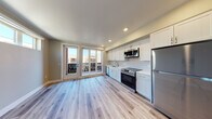 Located at 1235 Oakmead Pkwy in Sunnyvale, CA, this single-floor space offers a contemporary, open-concept design characterized by clean lines and a bright, airy atmosphere. Light wood-look flooring runs consistently throughout the unit, providing a cohesive and modern aesthetic.

The kitchen is a standout feature, outfitted with crisp white shaker-style cabinetry extending to the ceiling for generous storage. A white subway tile backsplash complements the bright countertops, while a full suite of stainless steel appliances—including a refrigerator, electric range, built-in microwave, and dishwasher—provides a polished, functional cooking space. A stainless steel undermount sink with a contemporary faucet anchors the workspace.

The open living area adjoins the kitchen seamlessly, benefiting from recessed lighting and neutral-toned walls. A set of glass-paned doors leads directly to a private balcony, allowing natural light to fill the space and offering outdoor views of the surrounding community.

The bathroom maintains the same modern aesthetic, featuring a white vanity with a clean countertop, a mirror, and wood-look flooring that ties back to the rest of the unit. Closet storage is also present, adding practical functionality to the overall layout.