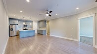 Located at 200 W Edge Way in Lynchburg, VA, this well-appointed single-floor residence offers a thoughtfully designed layout with 1 bedroom, 2 bathrooms, and a seamless blend of modern finishes throughout. The open-concept kitchen and living area serves as the heart of the home, featuring light hardwood-style flooring, crown molding, and a ceiling fan with recessed lighting. The kitchen is equipped with gray shaker-style cabinetry, a subway tile backsplash, stainless steel appliances, and a large center island with a white quartz countertop, undermount sink, and pendant lighting — ideal for both cooking and entertaining. A pantry provides additional storage. The living area opens to a private balcony through elegant dark-framed French doors, filling the space with natural light. The spacious bedroom is finished with plush carpet, a ceiling fan, and direct access to a full en-suite bathroom featuring a dual-sink vanity with quartz countertops, tile flooring, and a shower-tub combination. A second bathroom offers a single vanity and tile flooring. The dedicated laundry room includes a full-size washer and dryer alongside additional gray cabinetry and a quartz folding surface, rounding out this efficiently designed and well-finished residence.