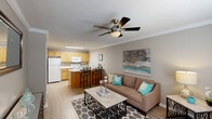 Located at 180 W Dublin Dr in Madison, Alabama, this single-floor residence offers a practical and well-designed layout across its living spaces. The living room serves as the heart of the home, featuring light wood-style flooring, crown molding, a ceiling fan, and a textured ceiling. Natural light filters in through blinds-fitted windows, creating a bright and welcoming atmosphere, while ample wall space accommodates decorative touches.

The kitchen is thoughtfully designed with light wood cabinetry, white appliances including a coil-top range, built-in microwave, refrigerator, and dishwasher. A mosaic tile backsplash adds visual interest, while the dual-basin sink and generous counter space provide functional prep areas. A peninsula with bar seating connects the kitchen to the main living area, making it ideal for casual dining.

The bedrooms are carpeted for comfort, each equipped with a ceiling fan and natural light from windows with blinds. The rooms offer sufficient space for furnishings and storage. The bathroom features a single-sink vanity with warm wood cabinetry, a shower/tub combination, and a well-lit mirror. Throughout the home, neutral tones and consistent finishes create a cohesive, move-in-ready environment.