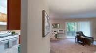 Located at Cowesett Hills Apartments in Warwick, Rhode Island, this single-floor residence offers a well-organized layout designed for comfortable everyday living. The living room is generously proportioned, featuring plush wall-to-wall carpeting, neutral-toned walls, and a sliding glass door that opens to a private balcony overlooking lush, mature trees — filling the space with natural light and greenery. A wall-mounted air conditioning unit and baseboard heating ensure year-round comfort.

Adjacent to the living area, the dining room features a ceiling fan with light fixture, a window with vertical blinds, and direct access to the kitchen, which is outfitted with warm wood cabinetry, granite-style countertops, a stainless steel sink, and tile flooring throughout.

The unit includes multiple bedrooms, each with soft carpeting, neutral walls, and ample closet storage. The primary bedroom is notably spacious, offering room for full-size furnishings and a dedicated closet. A secondary bedroom provides flexible use as a guest room or home office.

Throughout the unit, a cohesive neutral color palette and carpeted floors create a calm, welcoming ambiance, making this Cowesett Hills apartment a comfortable retreat in a well-established Warwick community.