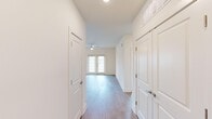 This well-designed single-story home in Athens, Alabama offers four bedrooms, two bathrooms, and a thoughtfully laid-out floor plan. The open-concept kitchen and living area serves as the heart of the home, featuring white shaker cabinetry, a subway tile backsplash, stainless steel appliances, a granite-topped island with pendant lighting, and light wood-style flooring that flows throughout the main living spaces. A wide hallway connects the bedrooms, offering a sense of openness as it leads to double French doors at the end that invite natural light into the space. The bedrooms are generously proportioned — some featuring plush carpeting and ceiling fans, others with light hardwood-style flooring — and each is brightened by large windows with views of the surrounding neighborhood. The primary bedroom includes a ceiling fan and a well-sized layout suited for comfortable living. The bathrooms are finished with white tile walk-in showers with glass enclosures, granite countertops, white cabinetry, and framed mirrors. A dedicated dining room and closet round out the functional layout. Throughout the home, clean white walls, consistent trim work, and quality finishes create a bright, modern ambiance that is both practical and welcoming.