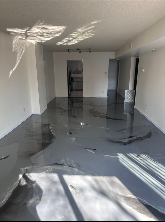 Living/ Dinning Area: With New epoxy flooring - 9200 Edwards Way Apartment