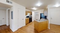 Located in Denham Springs, Louisiana, this 2-bedroom, 2-bathroom unit offers a practical and well-organized single-floor layout. Warm hardwood-style flooring flows consistently throughout every room, lending a cohesive and inviting feel to the entire space.

The kitchen is a functional highlight, featuring oak cabinetry with ample storage, light-toned countertops, a peninsula with a built-in sink, and black appliances including a range and refrigerator, complemented by a white dishwasher. A door from the kitchen connects directly to the dedicated laundry area, which includes shelving and dryer hookups for added convenience.

Both bedrooms are comfortably sized, with the primary bedroom offering generous square footage, a ceiling fan with light fixture, a window with outdoor views, and a double-door closet for ample storage. The second bedroom also features a window that brings in natural light and connects to its own full bathroom.

Each of the two bathrooms is finished with oak vanity cabinetry, light countertops, and a tub/shower combination, maintaining a consistent design language throughout. The neutral color palette of cream and white walls across the unit creates a clean, bright atmosphere that is easy to personalize. Overall, the layout is efficient and well-suited for comfortable everyday living.
