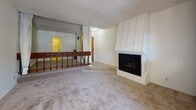 Located in the Westwood neighborhood of Los Angeles, this single-floor residence at 606 Levering Ave offers a functional and comfortable layout with several notable features throughout. The living room serves as the heart of the space, anchored by a white-paneled corner fireplace and carpeted flooring that extends across the main living areas. A mirrored wall accent and a dark wood railing detail add visual interest, while a textured popcorn ceiling is consistent throughout the unit. The dining area is brightened by a classic chandelier and sliding glass doors that open onto a private balcony, allowing natural light to flow in and providing outdoor views of the surrounding neighborhood. The kitchen is equipped with dark wood cabinetry reaching toward the ceiling for ample storage, light countertops with a tile backsplash, a gas range, a white refrigerator, a dishwasher, and tile flooring. A breakfast bar-style counter connects the kitchen to the dining and living areas. The bathroom features tile flooring, a vanity with light wood cabinetry, and a separate water closet. Throughout the unit, the layout is open and straightforward, offering a practical living environment in a prime Los Angeles location.