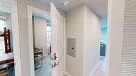 Located at 1338 W Jefferson Blvd in Los Angeles, CA, this 2-bedroom, 2-bathroom unit offers a thoughtfully designed single-floor layout that maximizes its compact footprint. The open-concept kitchen and living area serves as the heart of the home, featuring light wood-style flooring, a ceiling fan, and large windows on two sides that flood the space with natural light and offer elevated views of the surrounding neighborhood. The kitchen is outfitted with stainless steel appliances, white upper cabinetry, natural wood-toned lower cabinets, a quartz countertop, a deep single-basin sink, and a bold blue-and-white chevron tile backsplash that adds a distinctive design touch. The living area provides a clean, minimalist setting with neutral walls and ample room to relax. The primary bedroom features large windows with city views and a serene, light-filled atmosphere. The second bedroom includes carpeted flooring and its own window overlooking the neighborhood. Both bathrooms are finished with stylish herringbone blue tile in the shower enclosures alongside white subway tile accents and glass shower doors. The entryway includes a keypad-secured door and an in-unit electrical panel, adding practical convenience. Overall, the unit presents a modern, clean aesthetic with consistent attention to design detail throughout.