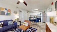 This two-bedroom, two-bathroom residence in Phoenix, Arizona offers a well-designed single-level floor plan that makes efficient use of its space. The open-concept living and dining area is bright and welcoming, featuring wood-look vinyl flooring, a ceiling fan, and a large window that brings in natural light. The living area flows directly into the dining space and kitchen, creating a cohesive entertaining zone. The kitchen is equipped with stainless steel appliances—including a refrigerator, range, and microwave—complemented by white upper cabinetry, contrasting lower cabinets, and a classic subway tile backsplash. Both bedrooms are comfortably sized, each featuring ceiling fans, plush carpeting, and windows with blinds. The two bathrooms are clean and functional, with white vanity cabinetry and light quartz-style countertops. A standout feature of this residence is the in-unit washer and dryer, conveniently housed within the second bathroom. The overall aesthetic is modern and neutral, with light tones throughout creating a cohesive and airy ambiance. Located at 6405 W McDowell Rd, this home offers practical, comfortable living in the heart of Phoenix.